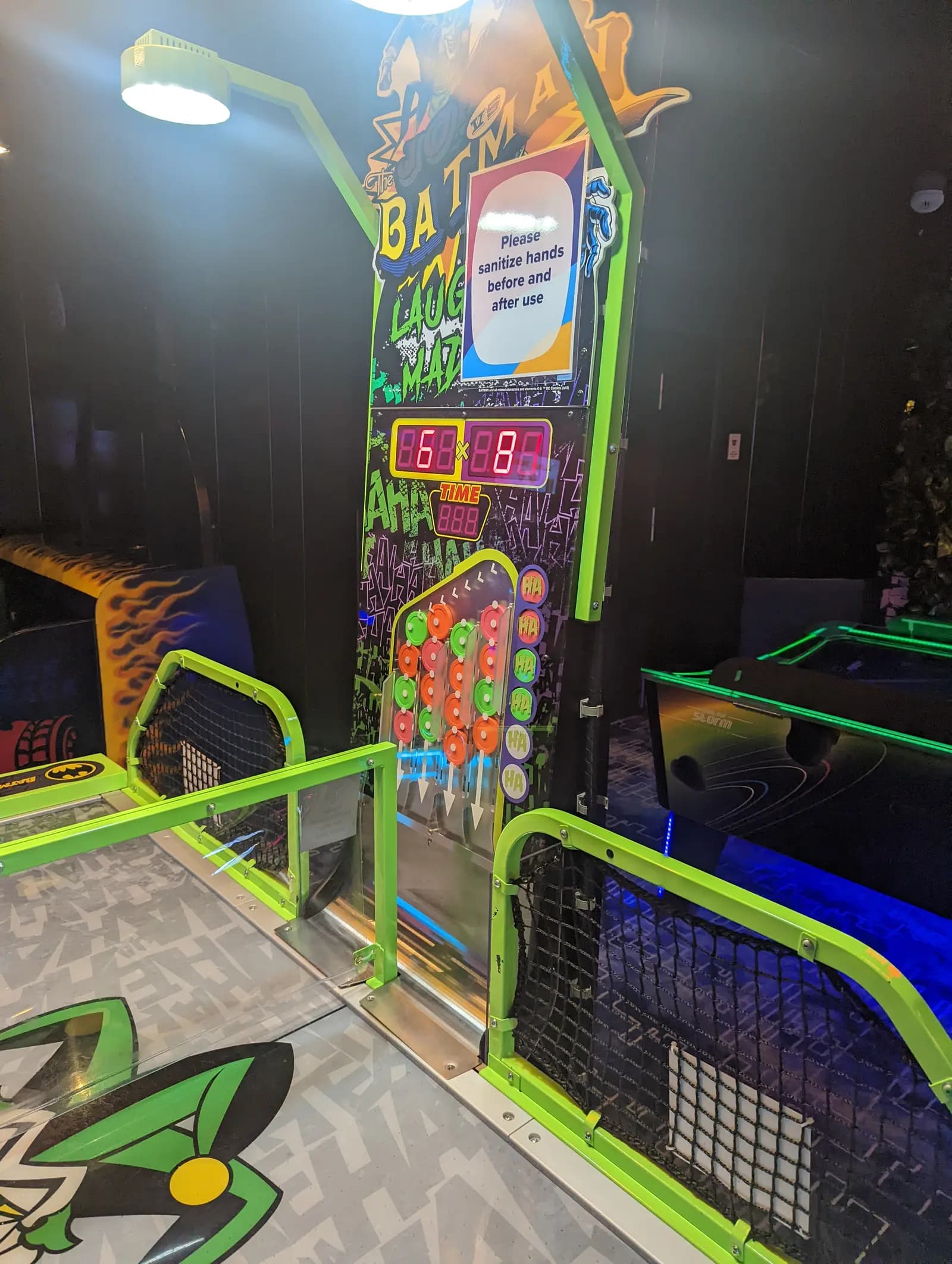 A neon-lit arcade game with a red digital score display in the arcade on Royal Caribbean's Allure of the Seas
